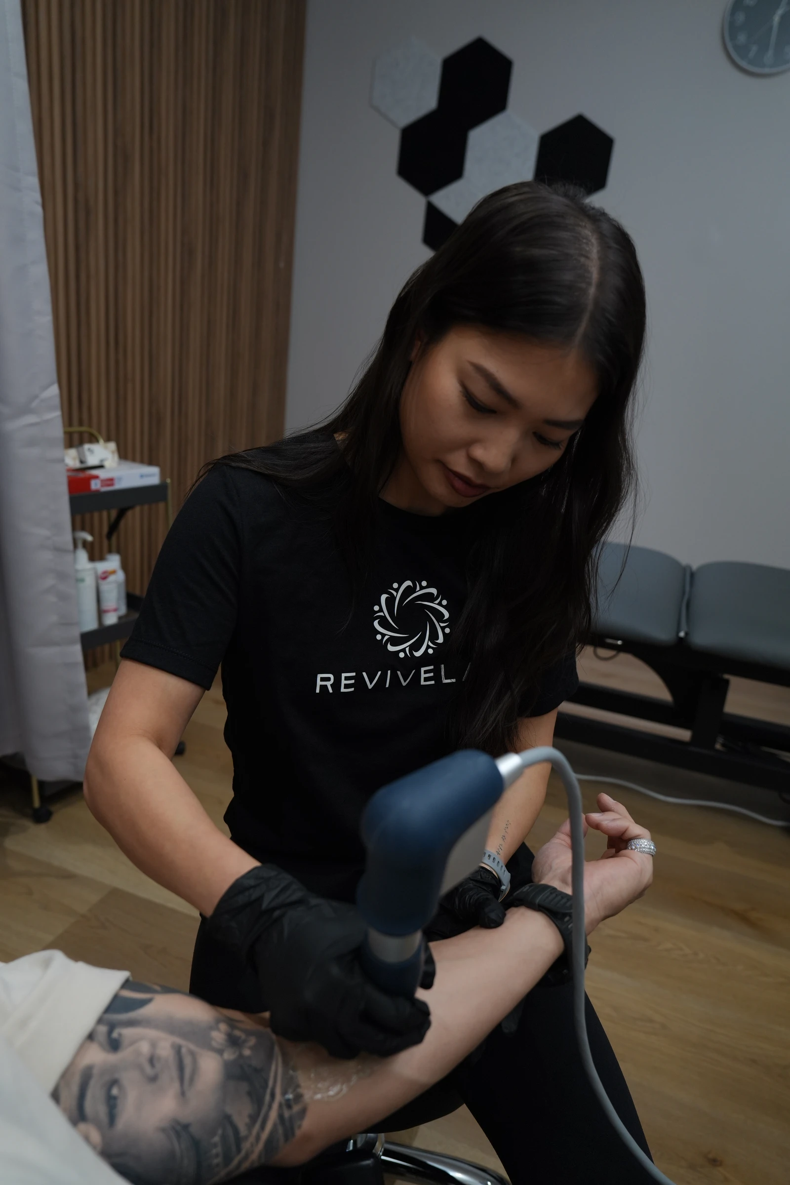 Melissa Chea providing hands-on physiotherapy care at REVIVELAB